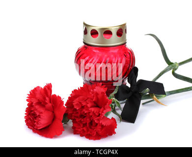 Memory lantern with candle,  carnations and black ribbon isolated on white Stock Photo