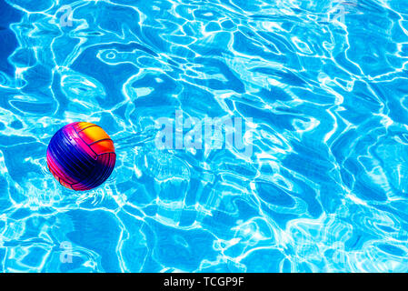 Colorful ball floating on a pool. Stock Photo