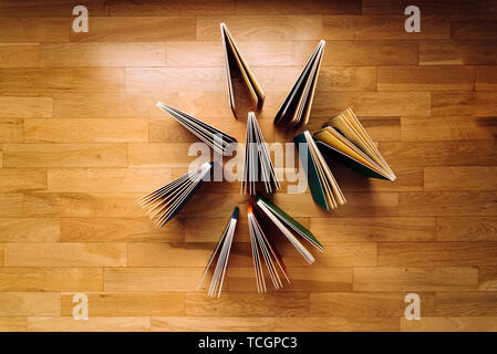 Several books of children's literature showing open on the wooden floor, background of books. Stock Photo