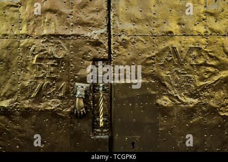 A polished old hammered brass door dated 1764 in the historic center of San Miguel de Allende, Guanajuato, Mexico. Stock Photo