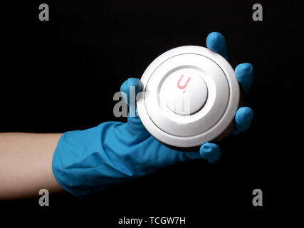 Uranium in hand isolated on black Stock Photo