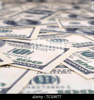 A pile of one hundred US banknotes. Cash of hundred dollar bills, dollar background image in perspective Stock Photo