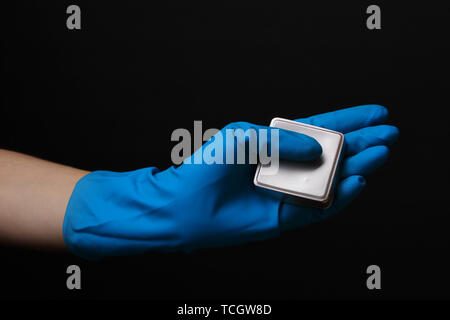 Uranium in hand isolated on black Stock Photo