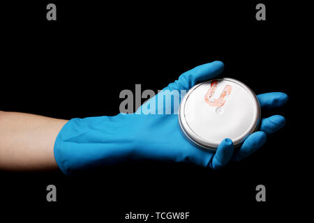 Uranium in hand isolated on black Stock Photo