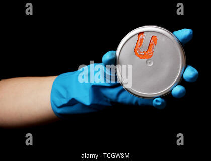 Uranium in hand isolated on black Stock Photo