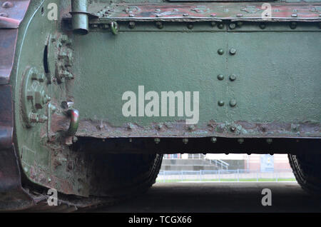 Abstract green industrial metal textured background with rivets and bolts. Old painted metal backdrop, detail of military tank surface corrosion, meta Stock Photo