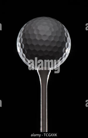 Golf ball on tee highlighted contrast tall epic Stock Photo