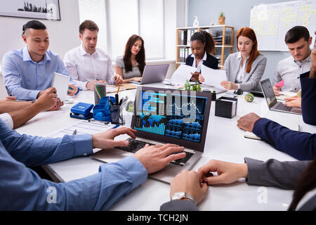 Close-up Of A Businessman Analyzing The Graph On Laptop In The Meeting Stock Photo