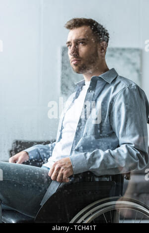 selective focus of sad disabled man on wheelchair Stock Photo