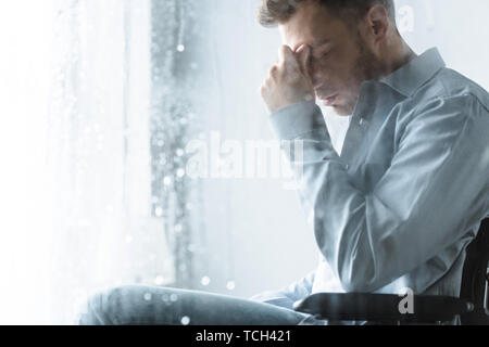 selective focus of sad disabled man on wheelchair Stock Photo