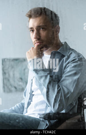 selective focus of sad disabled man on wheelchair Stock Photo