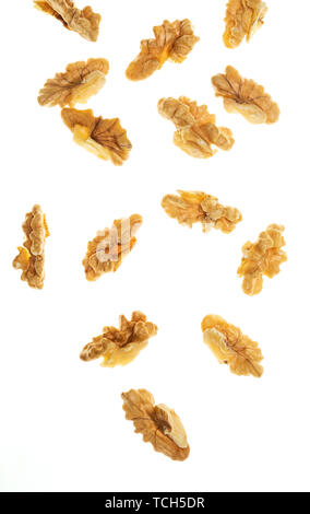 Peeled (open) nuts falling. Isolated on white background. Stock Photo
