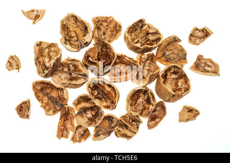 Walnut shells (open, broken) falling. Isolated on white background. Stock Photo