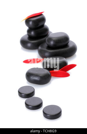 Spa stones and red petals isolated on white Stock Photo