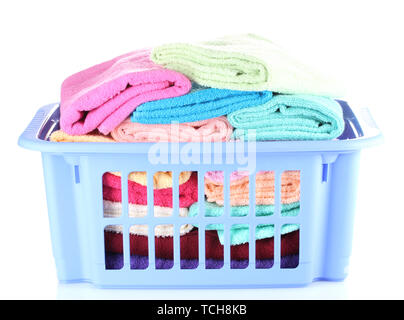 Plastic basket with bright towels isolated on white Stock Photo