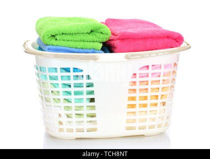Plastic basket with bright towels isolated on white Stock Photo