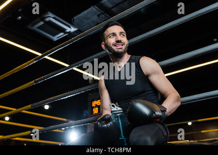 Boxing gloves in a low light room with black background Stock Photo - Alamy