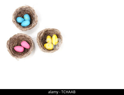 Colorful easter eggs in nests isolated on white Stock Photo