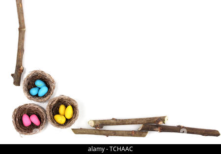 Colorful easter eggs in nests isolated on white Stock Photo