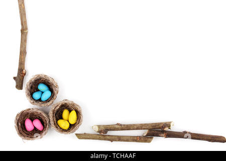 Colorful easter eggs in nests isolated on white Stock Photo