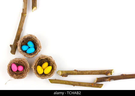 Colorful easter eggs in nests isolated on white Stock Photo