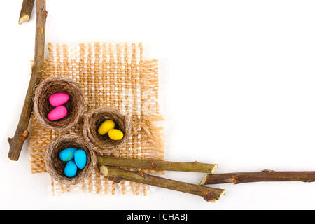 Colorful easter eggs in nests isolated on white Stock Photo