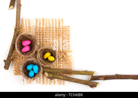 Colorful easter eggs in nests isolated on white Stock Photo
