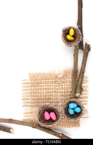 Colorful easter eggs in nests isolated on white Stock Photo