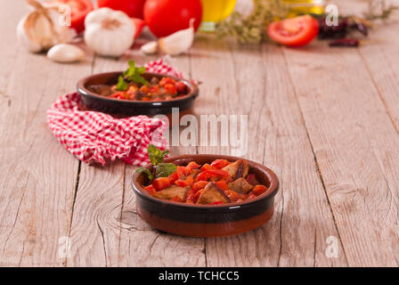 Marinated pork loin in tomato sauce. Stock Photo