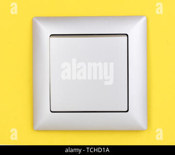 Modern light switch on yellow background Stock Photo