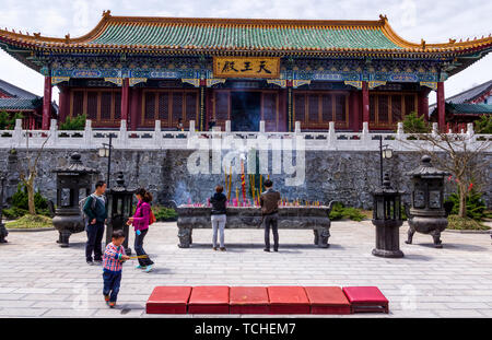 Zhangjiajie, Hunan, China Apr 2013 Group of Chinese people, preying in front of the temple on top of Tianmen Mountain. Tianmenshan Temple was built in Stock Photo