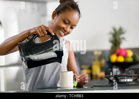 Indonesian woman making coffee in modern Indonesian woman making coffee Stock Photo
