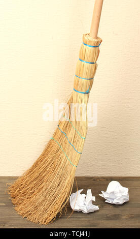 Broom and papers on floor in room Stock Photo