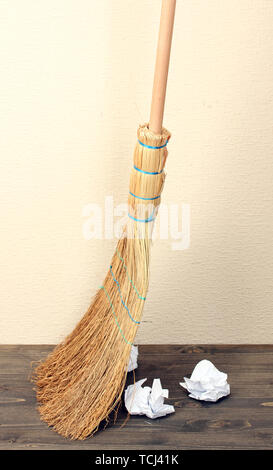 Broom and papers on floor in room Stock Photo