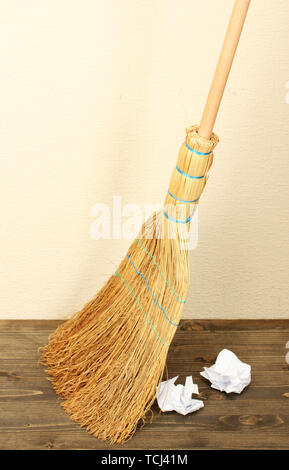 Broom and papers on floor in room Stock Photo