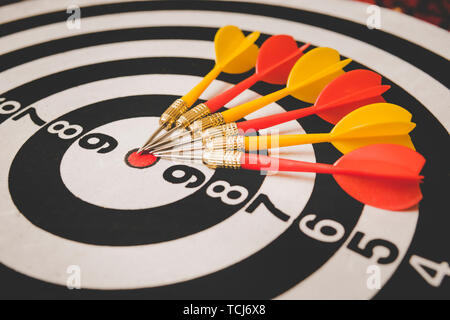 dart arrow hitting in the target center of dartboard,abstract of success Stock Photo