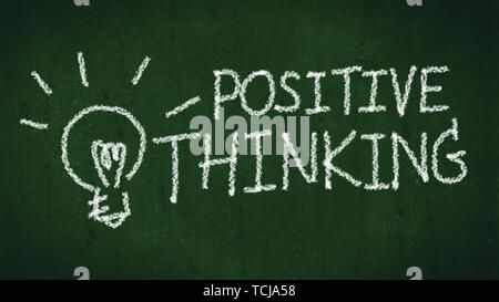 positive thinking concept. handwritten word positive thinking on black chalkboard with light bulb as idea Stock Photo