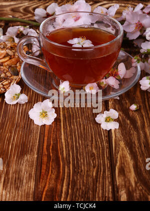 tea and a branch of cherry blossoms on a wooden Stock Photo