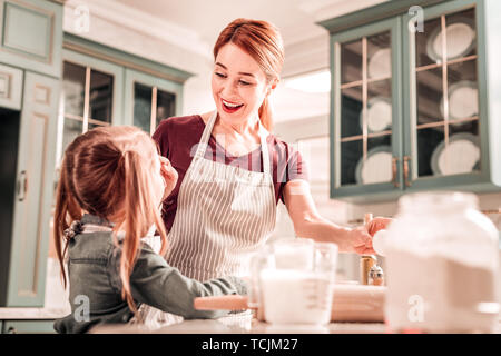 Positive delighted young mommy looking at her daughter Stock Photo