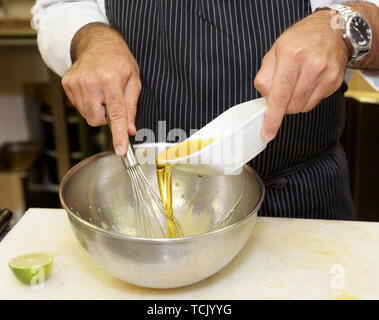 Chef is preparing sauce at restaurant kitchen Stock Photo