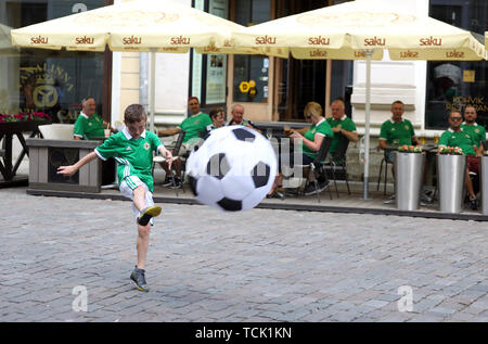 A young Northern Ireland fan plays football before the UEFA Euro 2020 Qualifying, Group C match at A. Le Coq Arena, Tallinn. Stock Photo