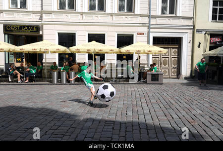 A young Northern Ireland fan plays football before the UEFA Euro 2020 Qualifying, Group C match at A. Le Coq Arena, Tallinn. Stock Photo