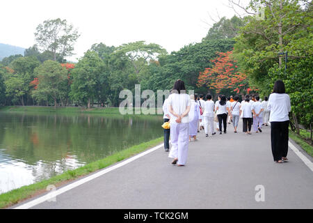 Chiang Mai, Thailand -  May 29, 2019: buddhist monk and people walking for meditation in Chiang Mai university in Chiang Mai, Thailand on May 29, 2019
