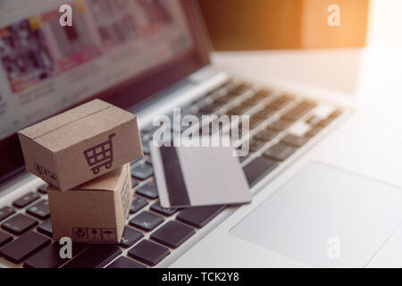 Shopping online concept - Shopping service on The online web. with payment by credit card and offers home delivery. parcel or Paper cartons with a sho Stock Photo