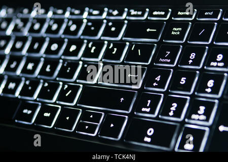Illuminated Keyboard. White light on the laptop keyboard. Stock Photo