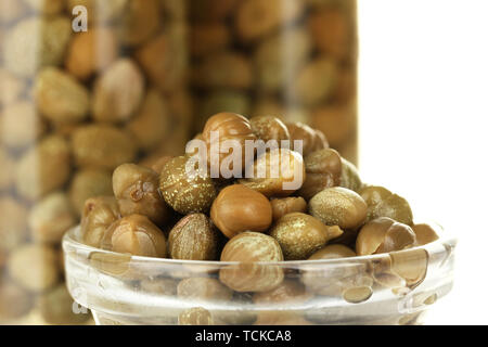 green capers in glass bowl on white background close-up Stock Photo