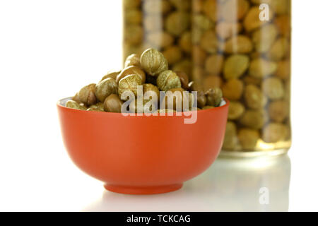 green capers in ceramical bowl on white background Stock Photo