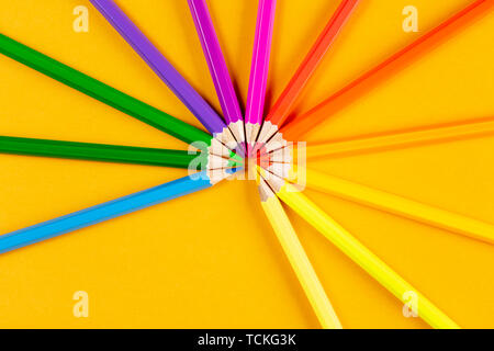 Colored pencils on yellow background Stock Photo