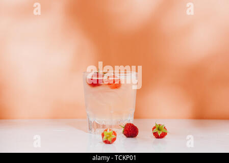 Summer juice with fresh raspberries in a glass on a light background Stock Photo