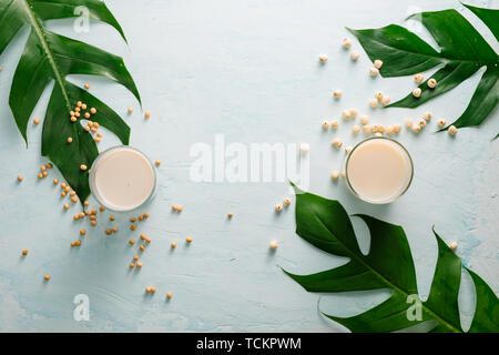 Soy milk or soya milk and soy beans on stone table. Stock Photo